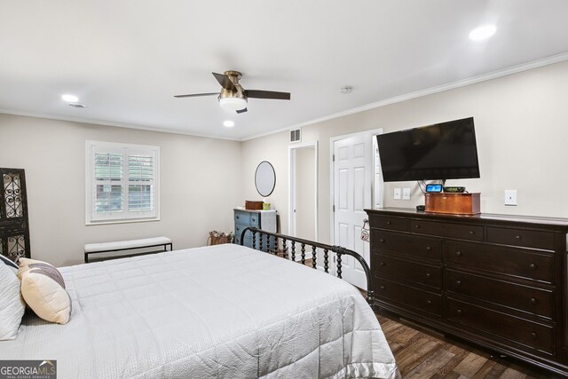 bedroom with dark hardwood / wood-style floors, ceiling fan, and crown molding