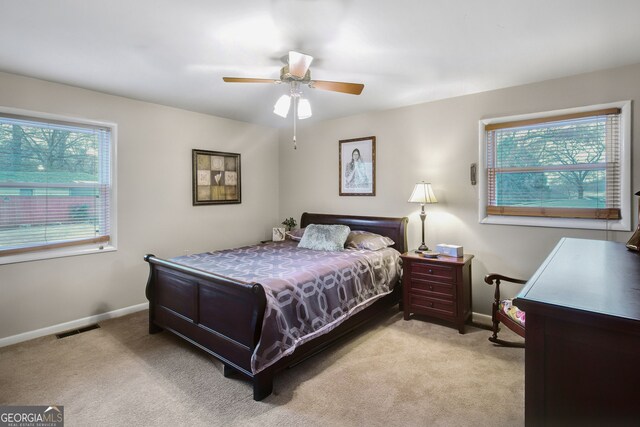 bedroom with light colored carpet and ceiling fan