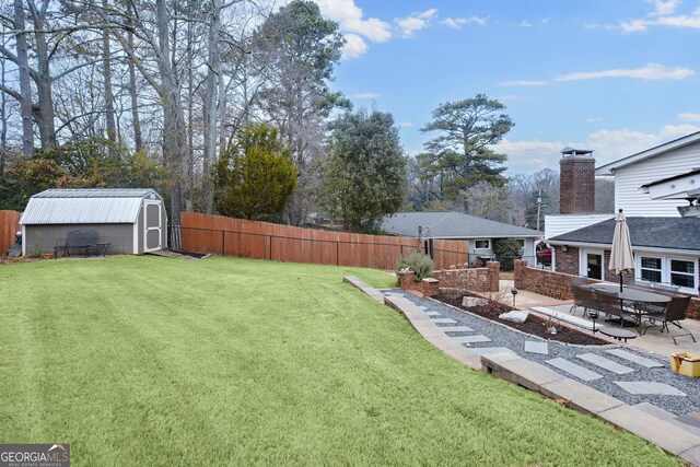 view of yard with a patio and a shed