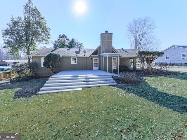 back of house with a lawn