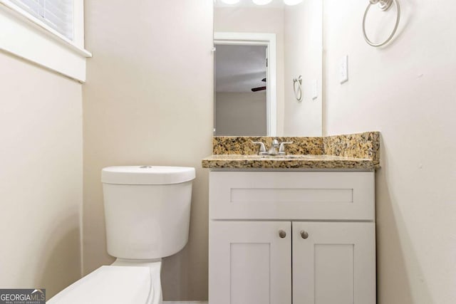 bathroom with ceiling fan, vanity, and toilet