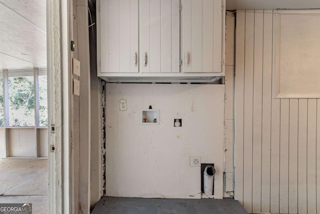 laundry area featuring hookup for an electric dryer, wood walls, cabinets, and hookup for a washing machine