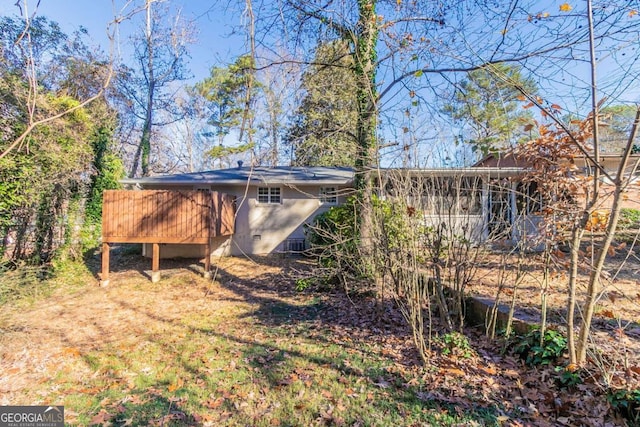 rear view of property featuring a deck