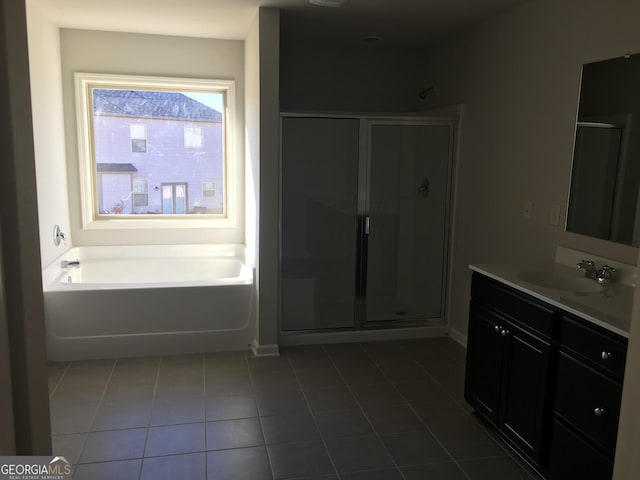 bathroom with tile patterned floors, vanity, and plus walk in shower