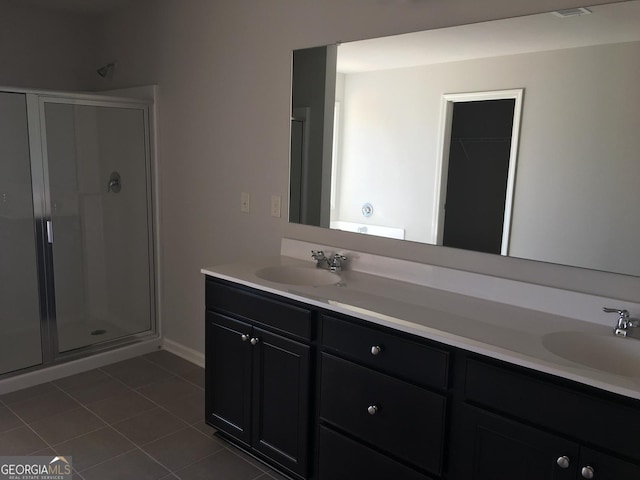 bathroom with tile patterned flooring, vanity, and a shower with shower door