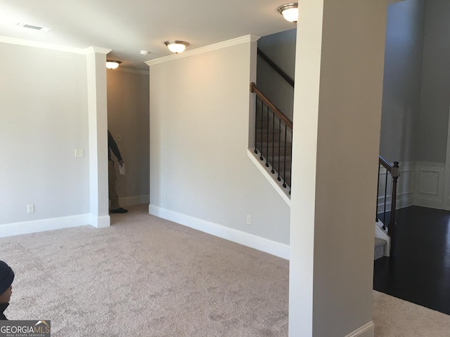 interior space featuring crown molding and carpet