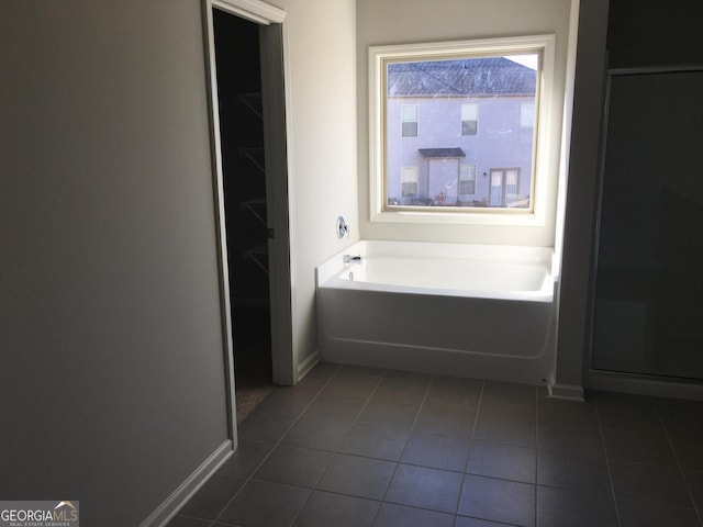 bathroom featuring tile patterned floors and a tub