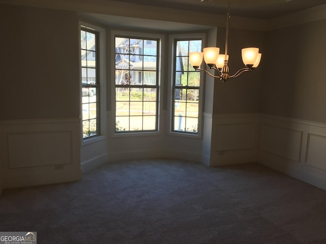 unfurnished dining area with a notable chandelier and carpet floors