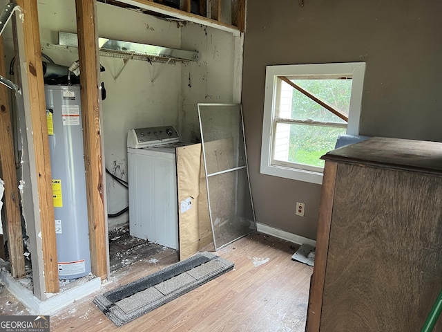 laundry area with wood-type flooring, washer / dryer, and water heater