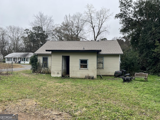 back of property featuring a lawn