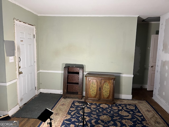 foyer entrance featuring wood-type flooring and ornamental molding