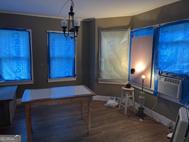 dining space featuring wood-type flooring, crown molding, and a chandelier