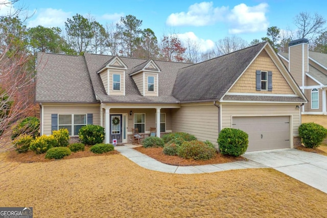 cape cod-style house featuring covered porch and a garage