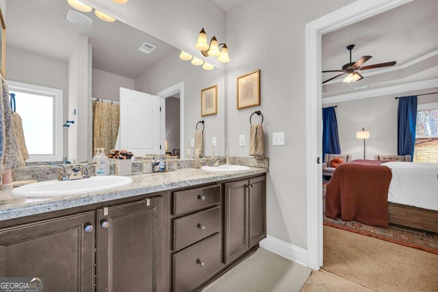 ensuite bathroom featuring ensuite bathroom, double vanity, a sink, and visible vents