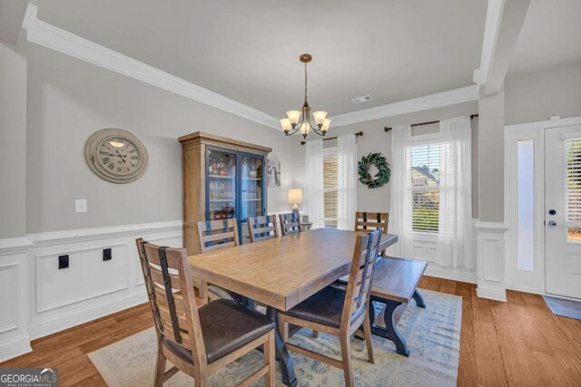 entryway featuring light wood-type flooring, a lit fireplace, and ceiling fan with notable chandelier