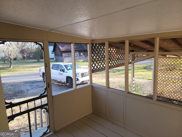 unfurnished sunroom with vaulted ceiling