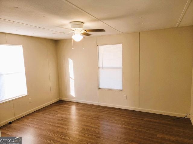 unfurnished room with ceiling fan, dark hardwood / wood-style flooring, and plenty of natural light