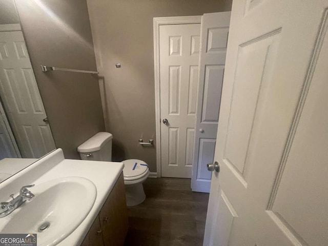 bathroom featuring toilet and vanity