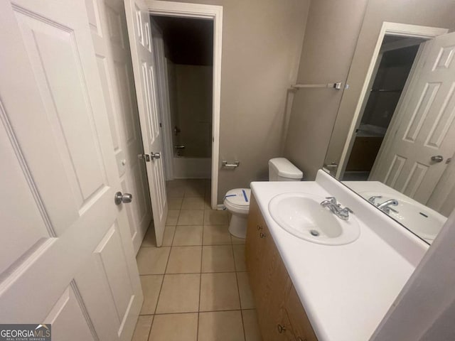 bathroom with tile patterned floors, vanity, and toilet