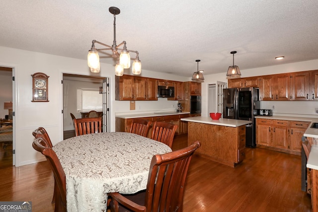 dining space with a textured ceiling and dark hardwood / wood-style floors