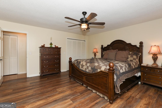 bedroom featuring ceiling fan, dark hardwood / wood-style flooring, and a textured ceiling