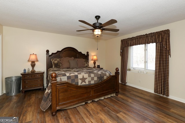 bedroom with a textured ceiling, ceiling fan, and dark hardwood / wood-style floors