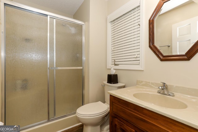 bathroom with vanity, toilet, and walk in shower