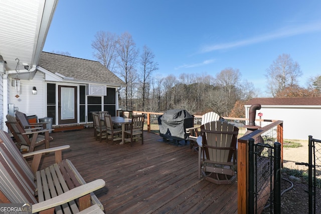 wooden deck featuring a grill