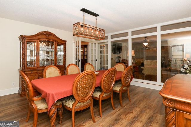 dining area featuring ceiling fan, french doors, and dark wood-type flooring