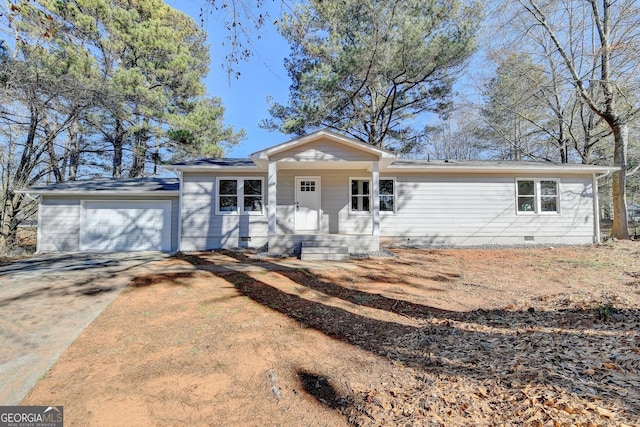 ranch-style house featuring covered porch and a garage