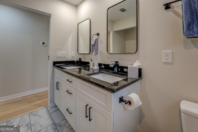 bathroom with vanity and toilet