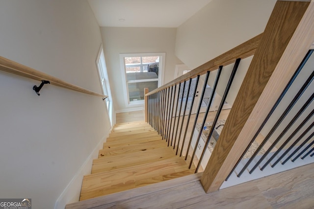 stairs featuring wood-type flooring