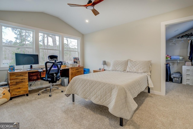 carpeted bedroom with a spacious closet, ceiling fan, lofted ceiling, and a closet