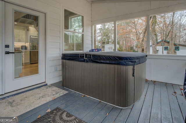 sunroom featuring a jacuzzi and lofted ceiling