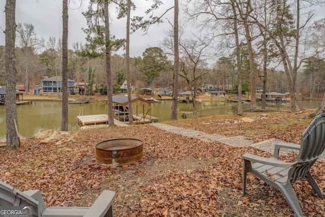 view of yard featuring a boat dock and a water view