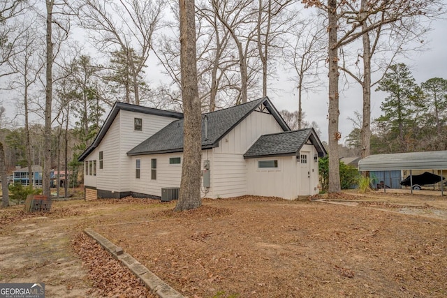 view of side of property featuring central AC unit and a carport