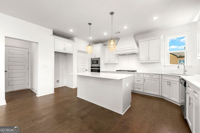 kitchen with white cabinets, a center island, premium range hood, and stainless steel appliances