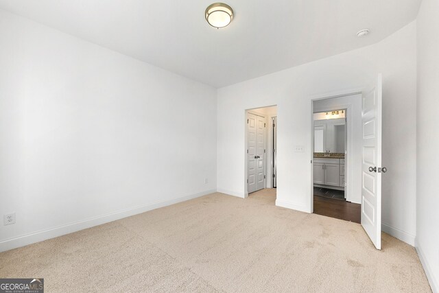 unfurnished bedroom featuring carpet floors and sink