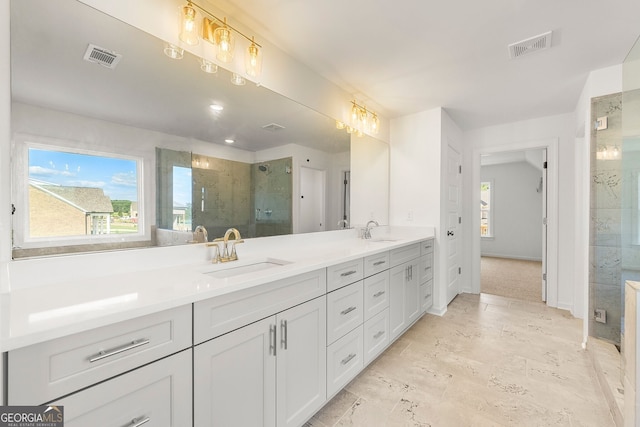 bathroom featuring a shower with door and vanity