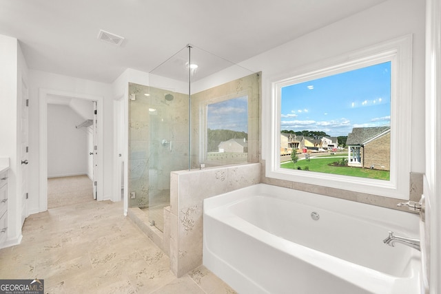 bathroom with vanity and plus walk in shower