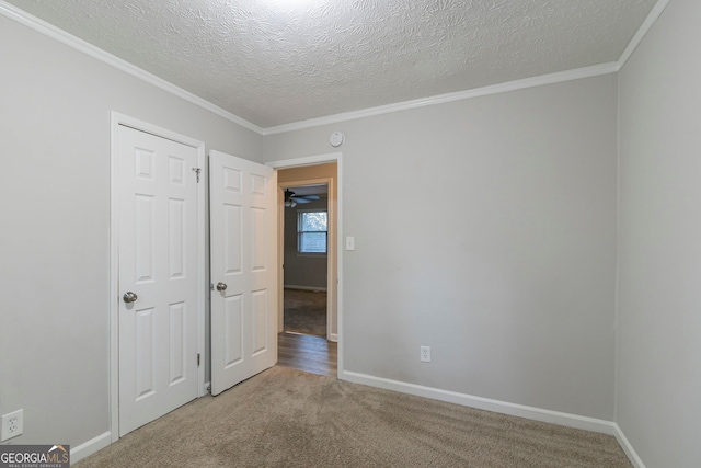 2098 Mallard Crst, Lithonia, GA 30058 - spare room with carpet floors, a textured ceiling, and crown molding