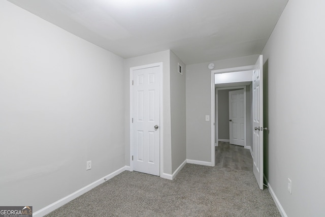 2098 Mallard Crst, Lithonia, GA 30058 - unfurnished bedroom with light colored carpet and a closet