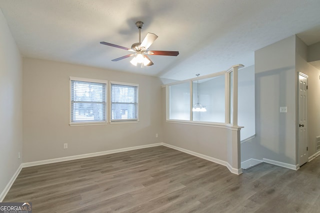 2098 Mallard Crst, Lithonia, GA 30058 - unfurnished room featuring ceiling fan, dark wood-type flooring, vaulted ceiling, and a textured ceiling