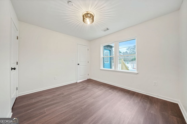 unfurnished room with dark hardwood / wood-style floors