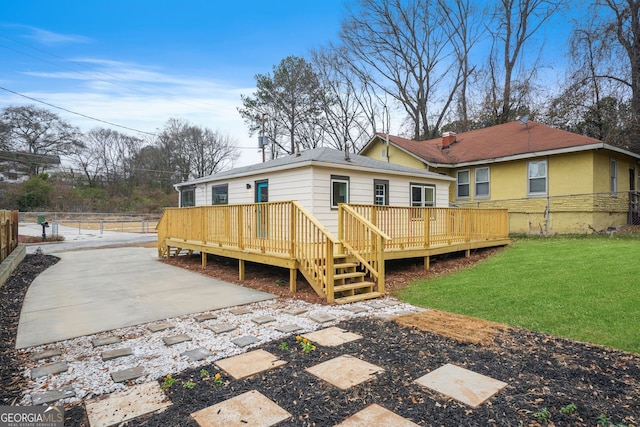 back of property with a wooden deck