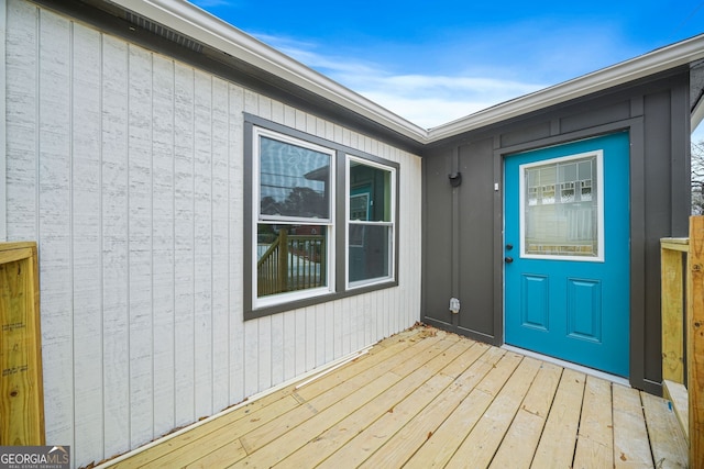 view of exterior entry with a deck