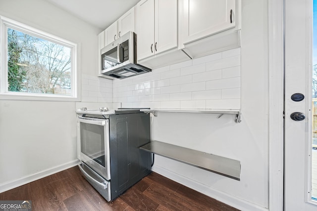 kitchen with decorative backsplash, appliances with stainless steel finishes, white cabinetry, and dark wood-type flooring