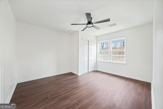 unfurnished room featuring dark hardwood / wood-style floors and ceiling fan