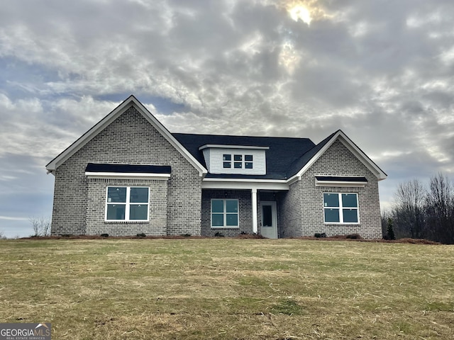 craftsman-style home featuring a front lawn and brick siding