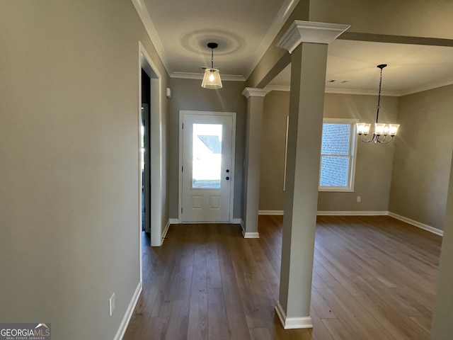 doorway to outside with baseboards, ornamental molding, wood finished floors, and ornate columns